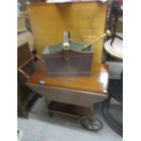 A 20th century mahogany tea trolley, a leather magazine rack and a brass fire poker