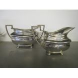 George V silver milk jug and sugar bowl, of London shape on four cushion ball shaped feet, gadroon