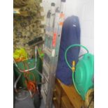 A large mixed lot to include a wheelbarrow, a ladder, gardening tools, CD rack and other items