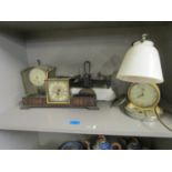 A group of clocks to include one mounted on a table lamp with adjustable white glass shade, along