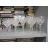 A set of eight red wine glasses and a set of six matching white wine glasses with line cut