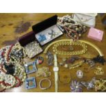 A quantity of costume jewellery to include vintage beads, brooches and a gold plated ladies