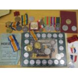 A selection of military related items to include service medals, Morse Code book and other items,