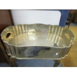 A large modern metal galleried serving tray with twin cut out handles