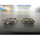 A white gold three stone diamond ring and an 18ct gold three stone diamond ring