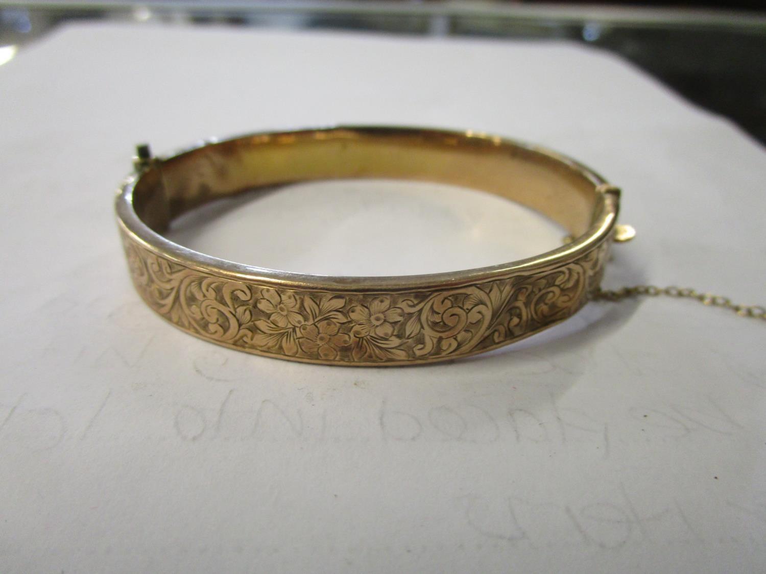 An early 20th century gold bracelet with engraved decoration