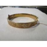 An early 20th century gold bracelet with engraved decoration