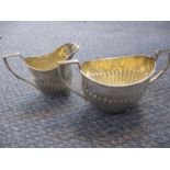 An early 20th century sugar bowl and creamer, both in silver, 133.7g