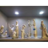 A quantity of Lladro and Nao figures to include a boy playing the cello