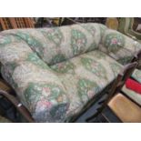 An early 20th century Chesterfield sofa stuffed with horsehair on oak bulbous feet, having a loose