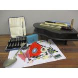 Costume jewellery, silver plated cake forks and serving spoon, an ebonized jewellery box in the form