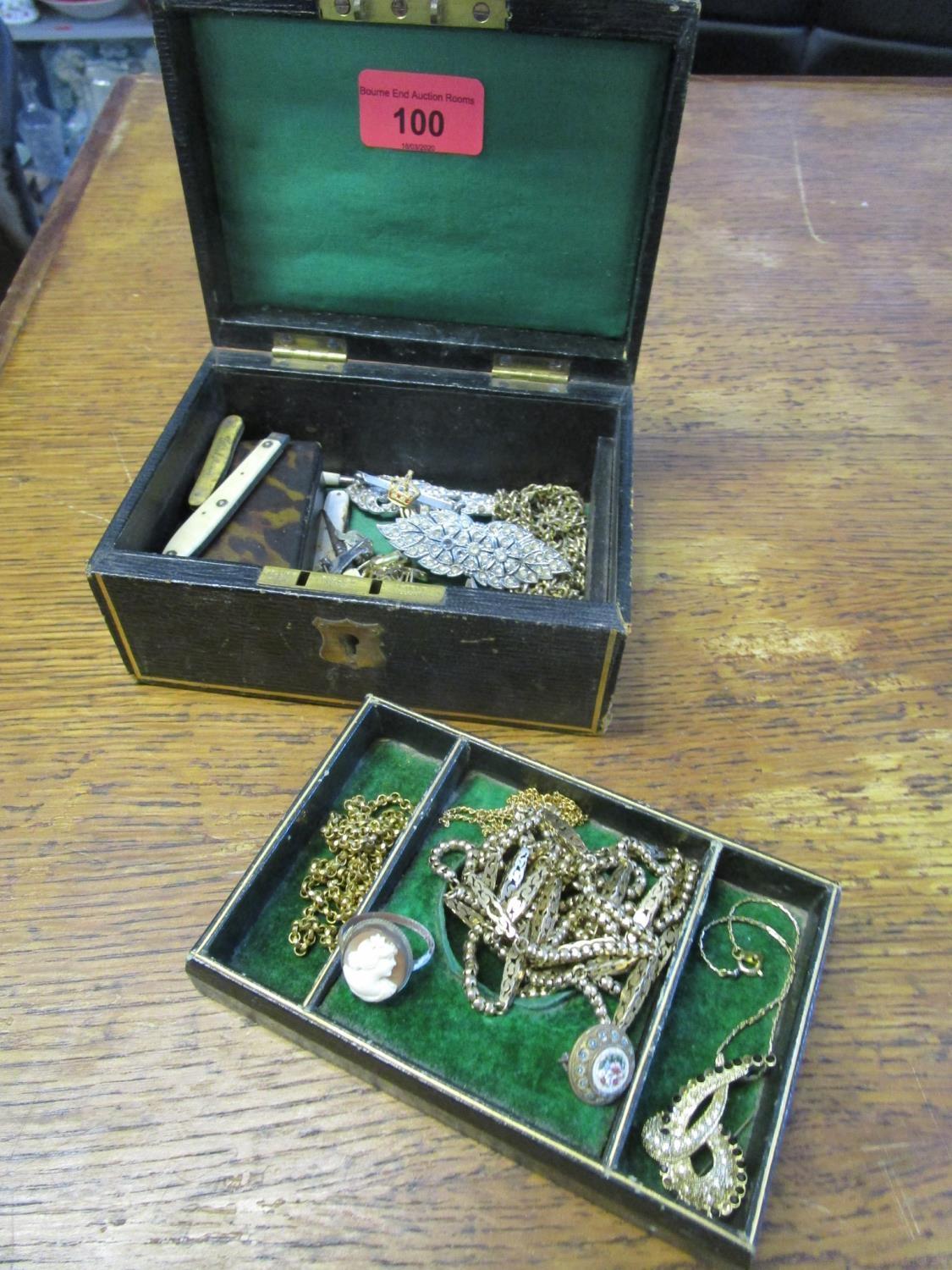 A small jewellery box containing a papier-mache snuff box, gold plated and gold coloured chains,