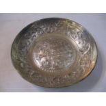 A white metal embossed bowl having beaded and scroll decoration
