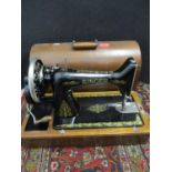 A 1921 Singer sewing machine in oak case, serial number Y2275 735