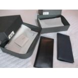 A pair of Valextra leather travel wallets, new in original boxes in black and navy