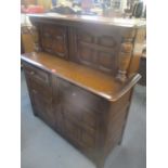A mid 20th century dark elm court cupboard having four cupboard doors and twin drawers, 49" h x 47