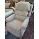 A modern oatmeal coloured chenille fabric upholstered electric reclining armchair