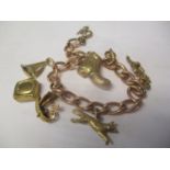 A gold coloured bracelet with six charms