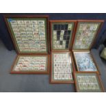 A quantity of framed and glazed sets of cigarette cards to include John Players & Sons, Past and