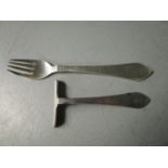 A Georg Jensen Danish sterling silver child's fork and pusher, stamped maker's marks to each