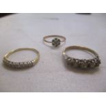 Three 9ct gold rings to include a daisy ring