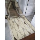 Two Egyptian hand-made wool rugs in tones of brown and cream with geometric motifs Location: C