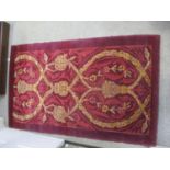 A Savonary style hand made rug with scrolled foliage and flowers on a puce ground Location: G