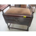 An early 20th century mahogany piano stool having two inset drawers