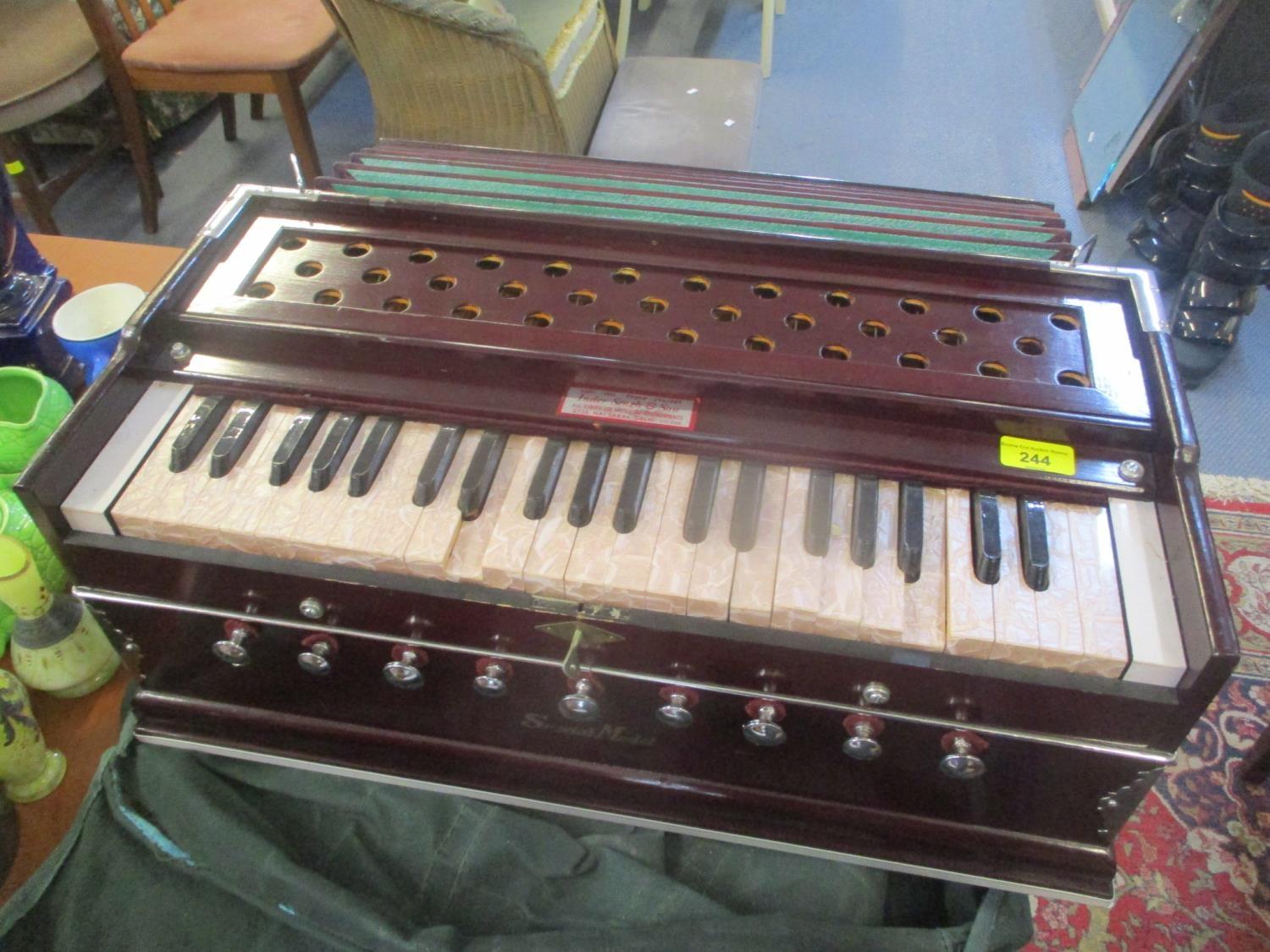 A special model laying style harmonium with a canvas carry case