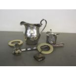 A mixed lot of silver items to include a milk jug and mustard pot