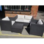 A modern woven plastic four piece garden suite comprising of two two seater sofas, a pair of