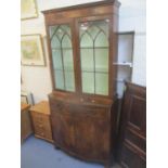 A reproduction mahogany display cabinet having two glazed doors above two drawers and cupboard