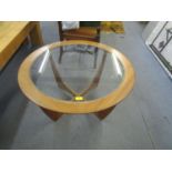 A G-Plan atomic teak coffee table with a glass top, on curved legs Location: RAB