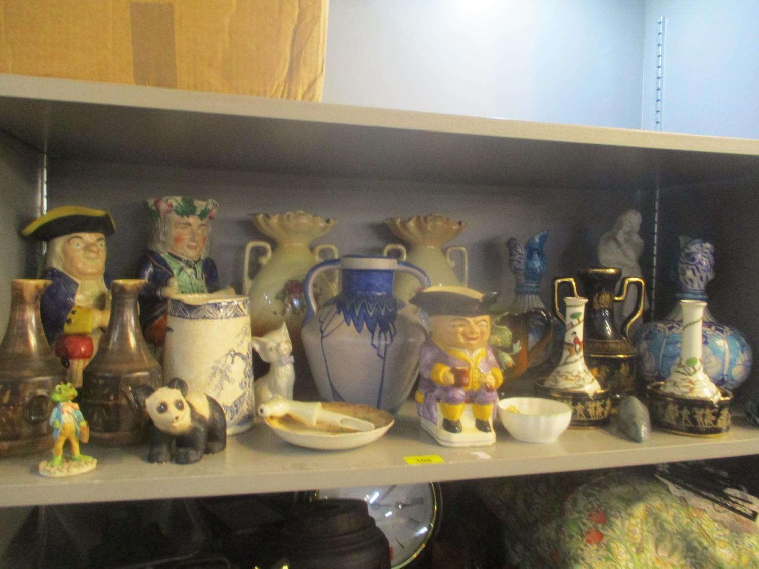 A mixed lot of china to include a Phoenix ware Celestine vase, Toby jugs, figurines of animals and