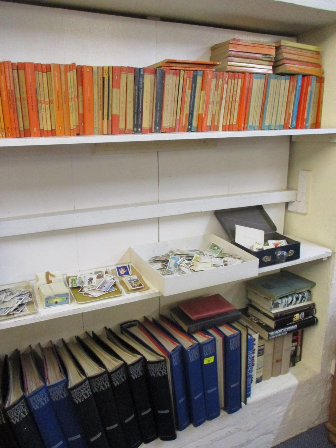 WWII collectors magazines in folders, early 20th century cigarette cards and Penguin and other books