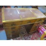 An early 20th century walnut, twin pedestal desk having a red leather top and nine drawers, 29 1/2"h