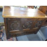 A 17th century oak coffer converted to have two cupboard doors above two short drawers, 31 1/4"h x