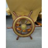 A vintage brass and wooden ships wheel Location: BWR