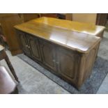 A modern American oak sideboard with four carved, panelled doors, on sturdy cabriole legs, 32"h,