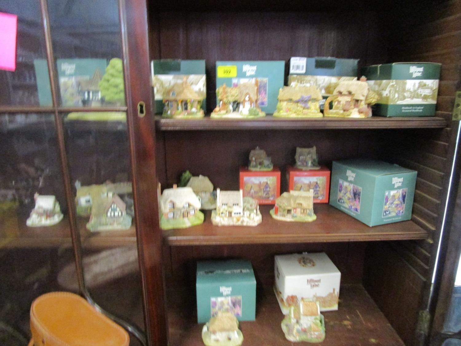 A group of Lilliput Lane cottages, some boxed