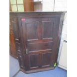 A Georgian oak panelled corner cabinet, together with an early 20th century walnut bedside