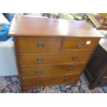 An early 20th century walnut chest o f two short and three long drawers having ring shaped handles