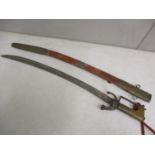 A Moroccan Scimitar having a treen handle with scabbard