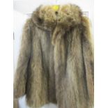 A racoon fur jacket with shawl style collar approximately 40" chest x 28" long