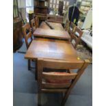 A modern French oak refectory dining table with a panelled top over two drawers on square legs and a