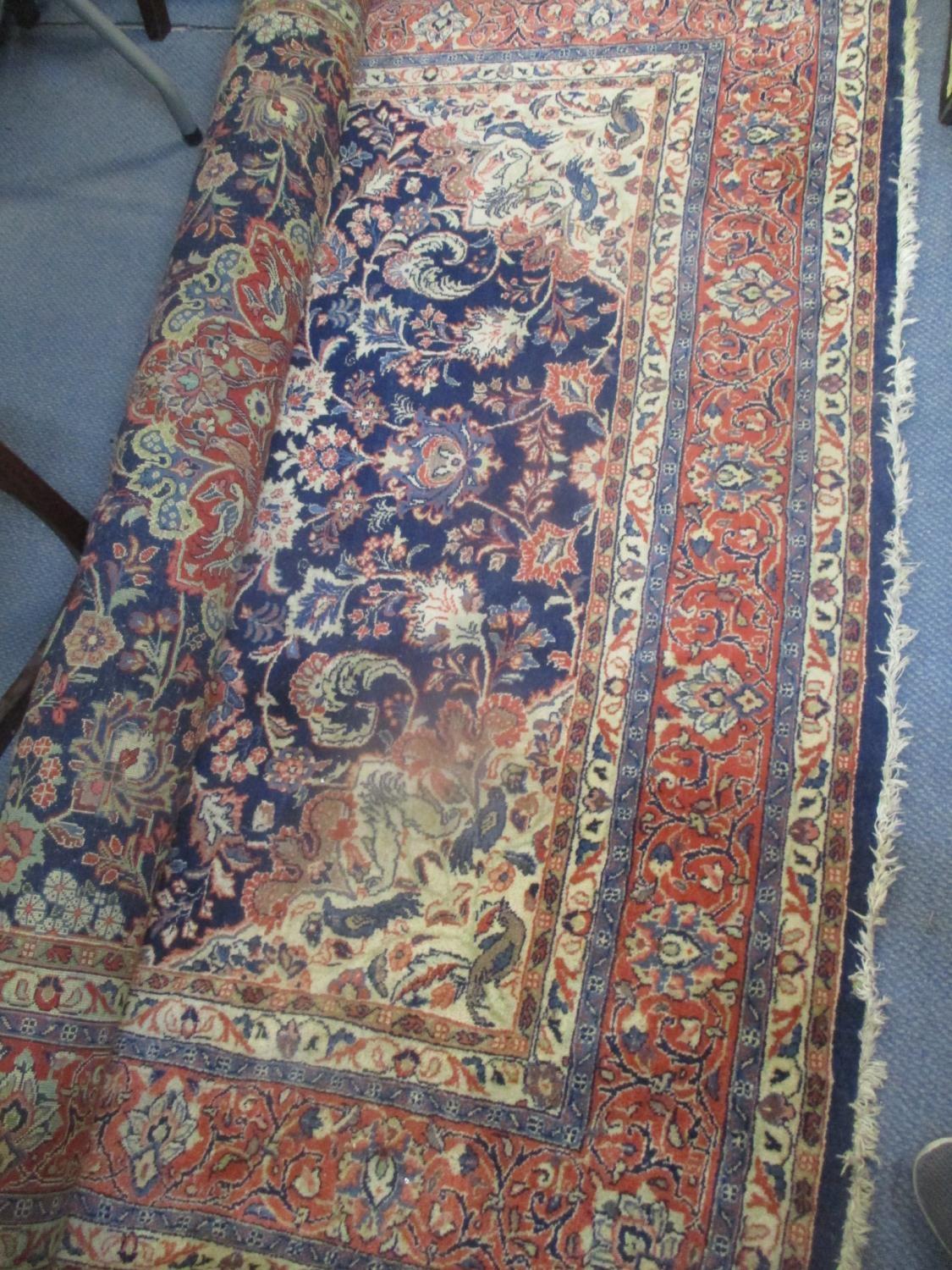 A Persian rug with a central medallion and flowering stems on a blue ground 70" x 47" Location: LAM