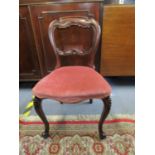 A mahogany child's balloon back chair with upholstered seat