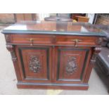 A late 19th century walnut French cabinet having two drawers with drop handles above two panelled