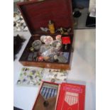 A Victorian mahogany box containing items of interest including retro badges, lighters, paper