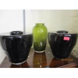 A pair of Calligaris dark glass vases and a single Calligaris green glass vase, all with makers